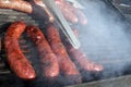 Sausages on a grill. Bratwurst on a barbecue. BBQ. Grilled sausages on bbq. Roasted meat sausages on a barbeque. Fast food outdoor Royalty Free Stock Photo