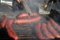 Sausages on a grill. Bratwurst on a barbecue. BBQ. Grilled sausages on bbq. Roasted meat sausages on a barbeque. Fast food outdoor Royalty Free Stock Photo