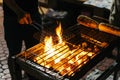 Sausages grill with burning charcoal with fire on the stove with grill on top in Bangkok, Thailand