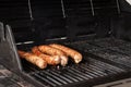 Sausages on the grill. Garden barbecue party. Pork sausages on the grill grate. Grilled bratwurst sausages. Royalty Free Stock Photo