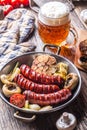 Sausages. Grill sausages. Grilled sausage with beer mushrooms garlic tomatoes and onions Royalty Free Stock Photo