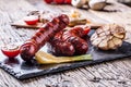 Sausages. Grill sausages. Grilled sausage with mushrooms garlic tomatoes and onions Royalty Free Stock Photo