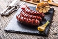 Sausages. Grill sausages. Grilled sausage with mushrooms garlic tomatoes and onions Royalty Free Stock Photo