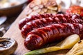 Sausages. Grill sausages. Grilled sausage with mushrooms garlic tomatoes and onions Royalty Free Stock Photo