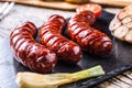 Sausages. Grill sausages. Grilled sausage with mushrooms garlic tomatoes and onions Royalty Free Stock Photo