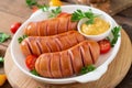 Sausages on the grill with vegetables. Royalty Free Stock Photo