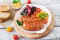 Sausages on the grill with vegetables. Royalty Free Stock Photo