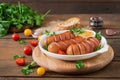 Sausages on the grill with vegetables. Royalty Free Stock Photo