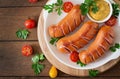 Sausages on the grill with vegetables. Top view Royalty Free Stock Photo