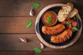 Sausages on the grill with vegetables. Top view Royalty Free Stock Photo