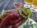 Sausages grilled beer salad recipe fried nutrition kitchen on a wooden background lettuce table Royalty Free Stock Photo