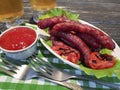Sausages grilled beer salad recipe parsley beef on a wooden background lettuce table Royalty Free Stock Photo