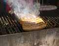 Sausages grilled on a smoky outdoor barbecue