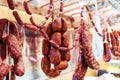 Sausages are hanged on the counter of a farm store. Trade in meat products. Close-up Royalty Free Stock Photo