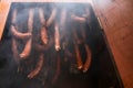 Sausages inside wooden smokers