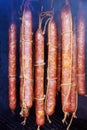 Meat hanging from a traditional smokehouse for smoking sausages.