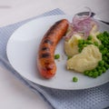 Sausages with mash and some peas Royalty Free Stock Photo