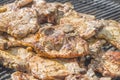 Sausages and pork steaks on the large barbeque Royalty Free Stock Photo