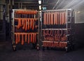 Sausages on racks in a storage room in meat processing factory.