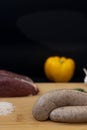 Sausages ready for cooking with raw ingredients