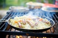 sausages and sauerkraut on grill, backyard cookout