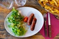 Sausages served with potatoes and salad Royalty Free Stock Photo