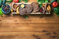 Sausages served with tomato sauce and mustard on a rustic board, top down view