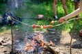 Sausages on stick bonfire background. Smoky smell of roasted food. How to roast sausages with vegetables. Roasty toasty Royalty Free Stock Photo