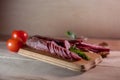 Sausages with tomato sauce on wooden background