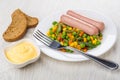 Sausages with vegetable mix, pieces of bread, bowl with sauce