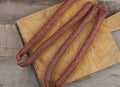 Sausages on a wooden kitchen board close up, cooking meat snacks Royalty Free Stock Photo
