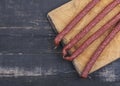 Sausages on a wooden kitchen board close up, cooking meat snacks Royalty Free Stock Photo