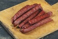 Sausages on a wooden kitchen board close up, cooking meat snacks Royalty Free Stock Photo