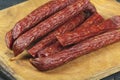 Sausages on a wooden kitchen board close up, cooking meat snacks Royalty Free Stock Photo