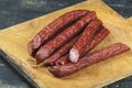 Sausages on a wooden kitchen board close up, cooking meat snacks Royalty Free Stock Photo