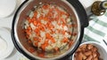 Saute chopped carrot and onion in a multi cooker.