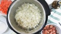 Saute chopped onion in a multi cooker. Cooking rice with meat and vegetables