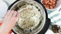 Saute chopped onion in a multi cooker. Cooking rice with meat and vegetables