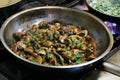 Saute mushrooms in a cooking pan