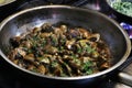 Saute mushrooms and onions in a frying pan on firel