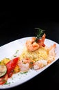 Saute shrimps, scallop, squid with pepper chilli with Mediterranian roast vegetable and saffron rice on white plate dark
