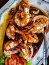 Saute shrimps with vegetables and tomato on plate in the restaurant.