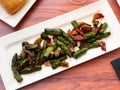 Sauteed asparagus with ham and foie chips closeup