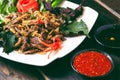 Sauteed beef with herbs and chili sauce on table