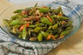 Sauteed chickpeas and anchovies on a small plate with a napkin