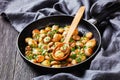 Sauteed garlic white mushrooms on a pan, close-up