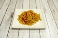 sauteed noodles with vegetables and strips of red peppers with soy sauce