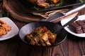 Sauteed sweet potato salad on black bowl on brown wooden background. Side dish for christmas, thanksgiving, and new year's eve din