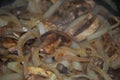 Sauteing mushrooms and onions in a frying pan with oil, seasoning, and steam