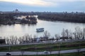 Sava and Danube River intersection. The excursion boat proceeds at sunset